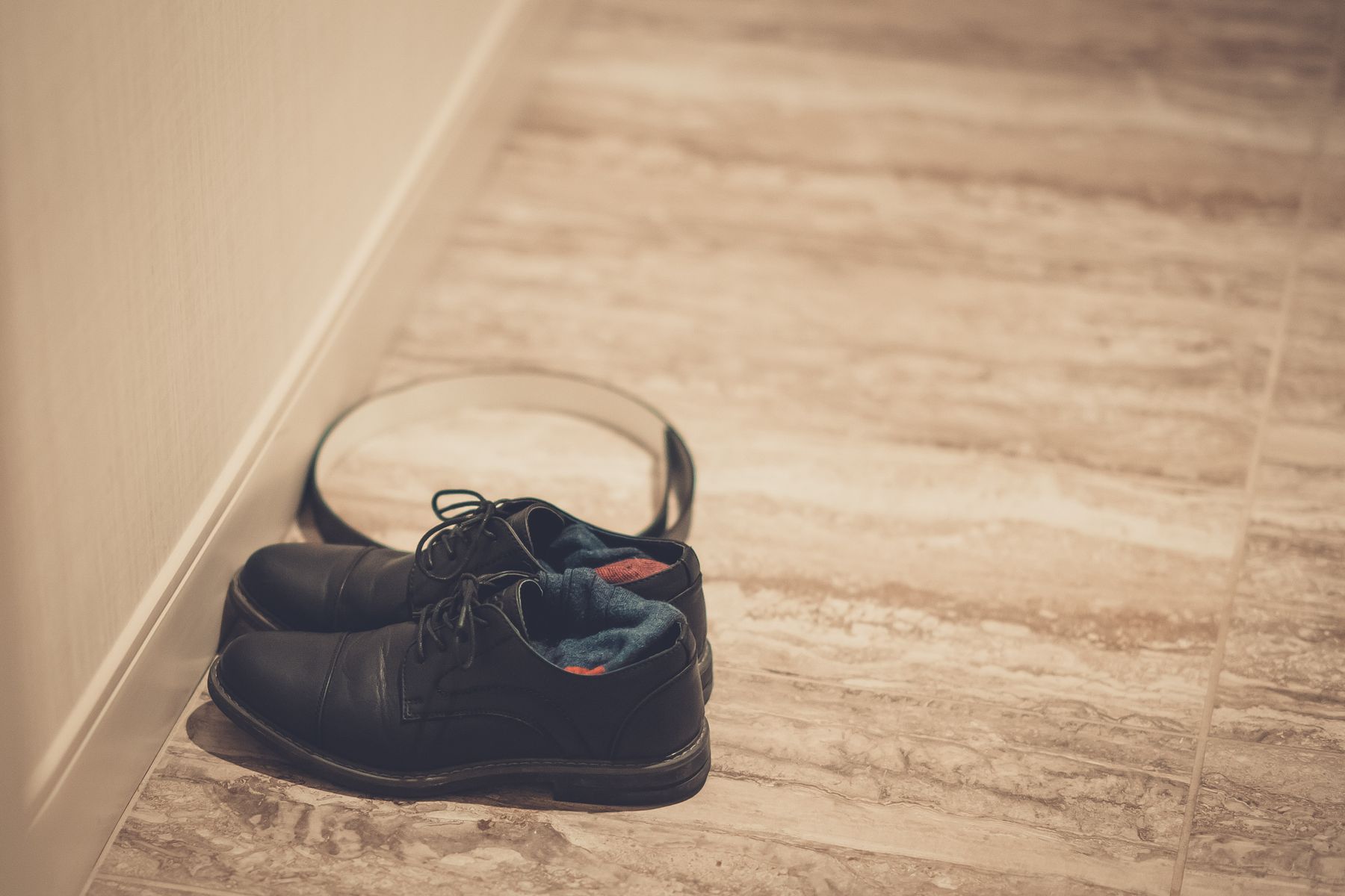 Wholesale shoes — black leather shoes on a stone floor